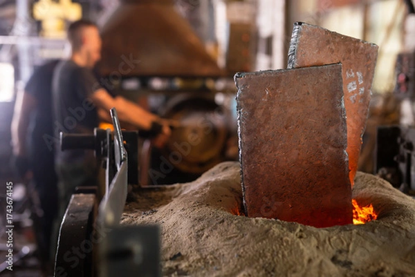 Fototapeta Ferrous metal billet is melted in an induction furnace closeup
