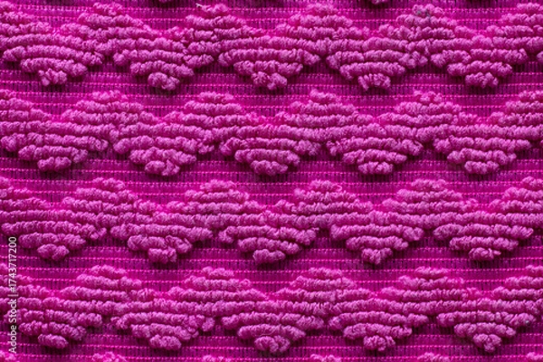Fototapeta Vibrant texture of pink fabric with intricate patterns creates a striking visual display in handmade textile art