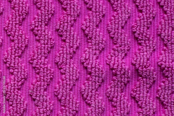 Fototapeta Intriguing texture in vibrant pink fabric showcasing zigzag patterns in soft, fluffy fibers on a cozy afternoon