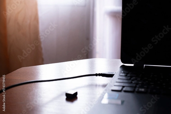 Obraz Quiet moments of creativity at a dimly lit workspace with a laptop on a wooden desk