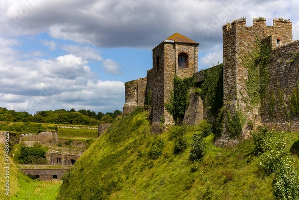 Fototapeta View across the grassy moat towards the medieval walls of historic Dover Castle, England