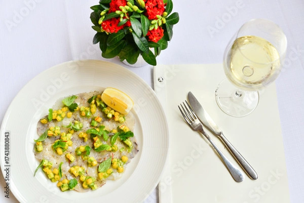 Fototapeta fish carpaccio garnished with corn and basil