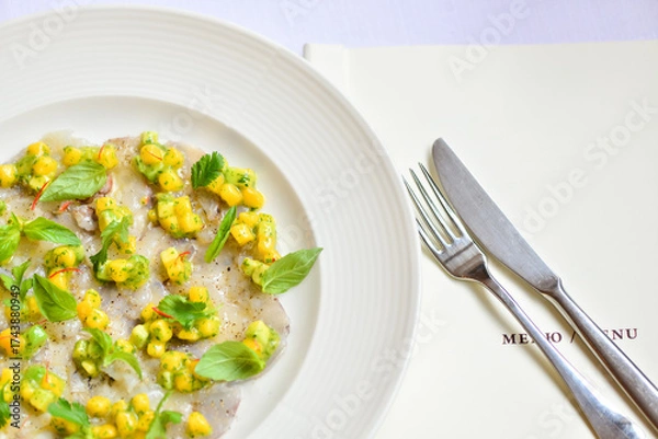 Fototapeta fish carpaccio decorated with corn and basil macro photo