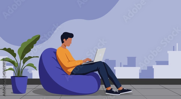 Obraz Man works on laptop on a bean bag in a modern comfortable workspace Remote work freelancing lifestyle