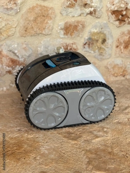 Obraz Automatic pool cleaning robot on stone floor
