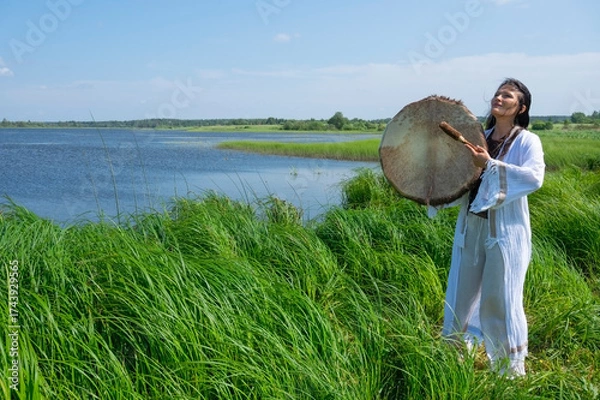 Obraz Shaman woman drumming in the natural environment