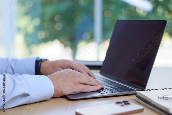 Obraz Man working on laptop at wooden table indoors, closeup