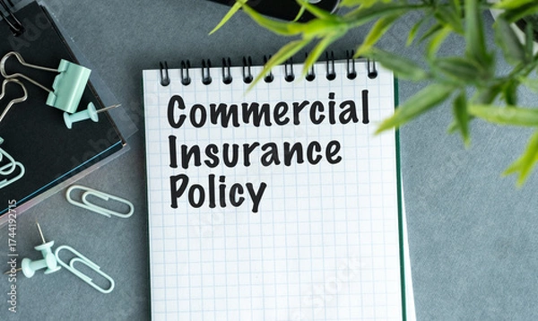 Fototapeta A notebook with the word Commercial Insurance Policy written on it.