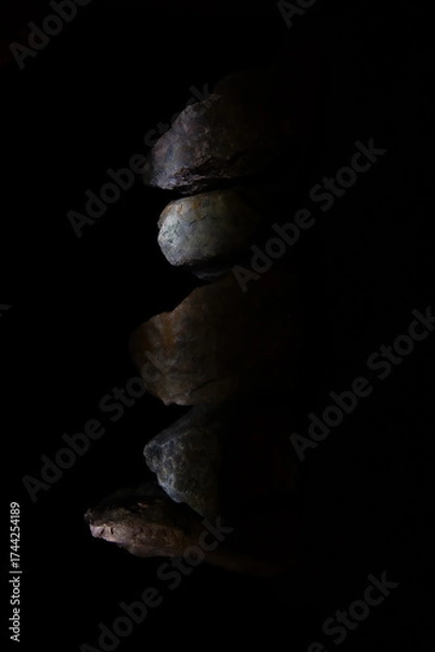 Fototapeta Dark Rock Stone Stack Side Lit Vertical Pile.
