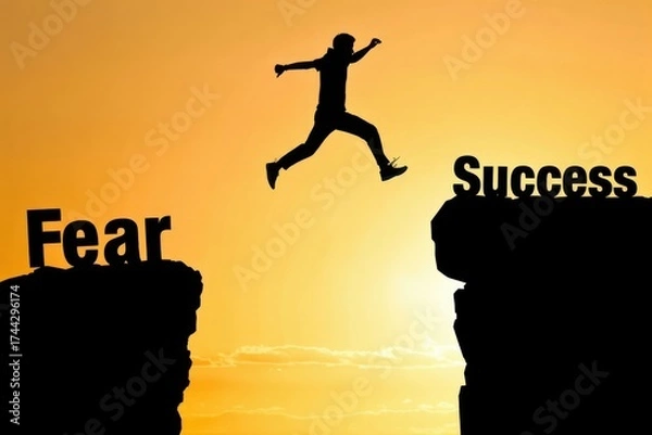 Fototapeta Silhouette man jumping over a gap from Fear to Success