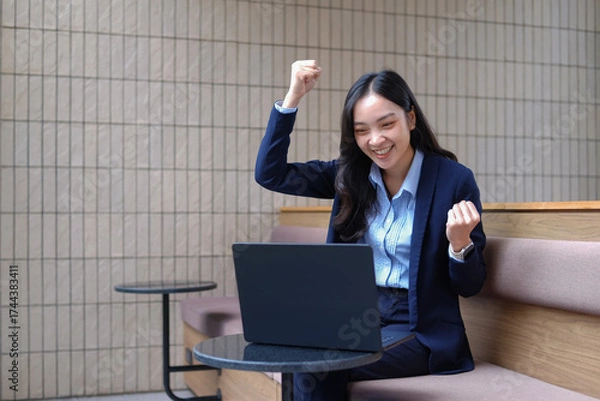 Obraz Professional businesswoman using computer for financial analysis in office, office space.