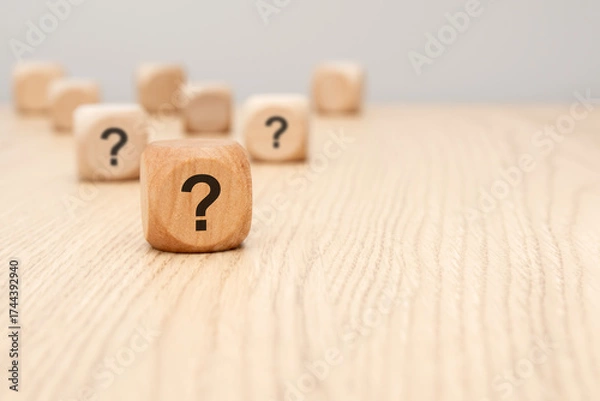 Fototapeta wooden cube with question mark in focus on wooden surface