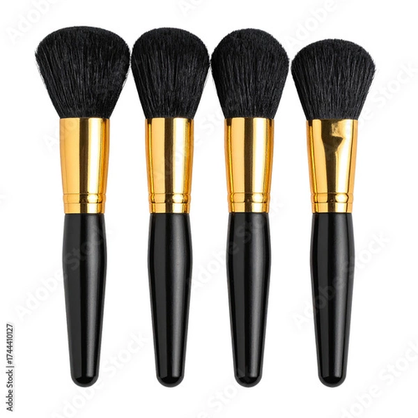 Fototapeta Four makeup brushes, black handles, golden ferrules, and dense dark bristles, arranged neatly