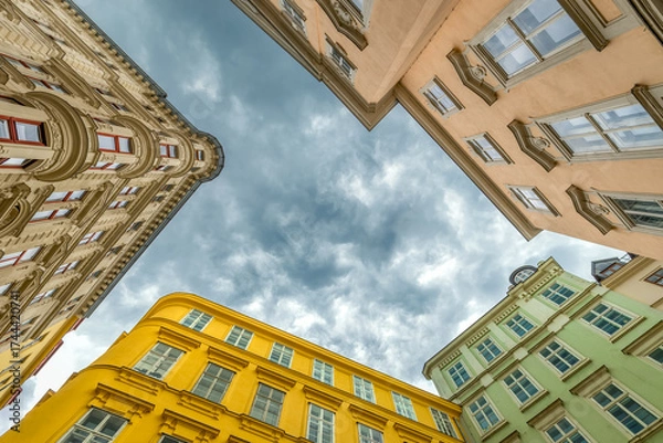 Fototapeta Old-style buildings in Vienna, Austria, on a cloudy day. from a low-angle perspective.
