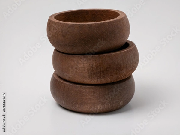 Fototapeta Stack of three handmade wooden bowls on white background