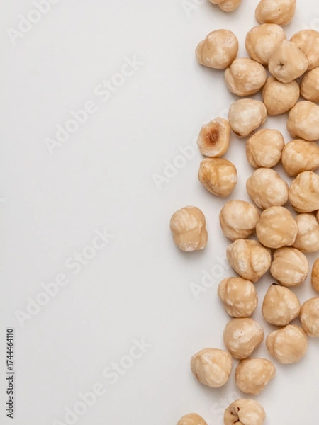 Fototapeta Raw hazelnuts on white background with copy space