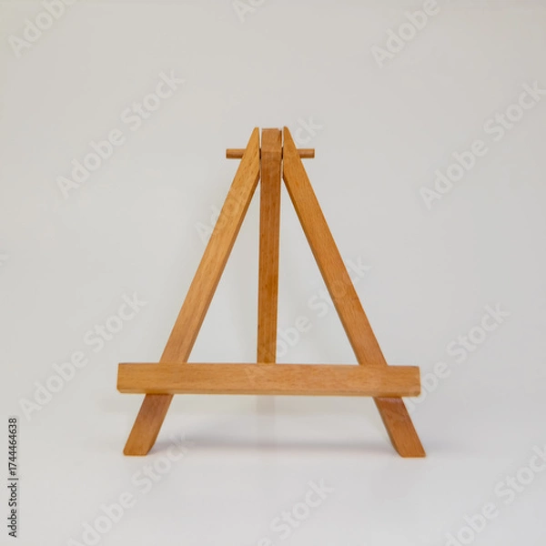 Fototapeta Wooden tabletop easel on white background for art display or painting