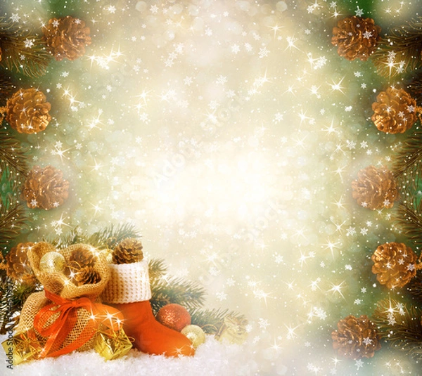 Fototapeta Christmas frame background with decorative Santa's red boot and gift bag, branch and pine cones for tree decoraton. New Year winter holidays fantasy concept with decor and copy space, festive postcard