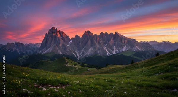 Fototapeta Scenic View Of Majestic Mountain Range During Vibrant Sunset With Colorful Sky And Wildflowers