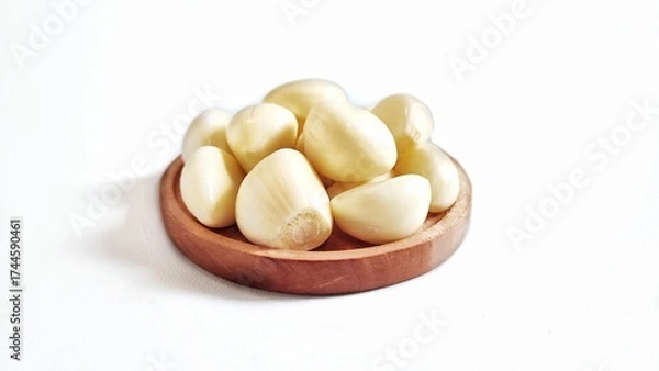 Fototapeta Garlic cloves and garlic bulb in a wooden plate. Isolated on white background with copy space. Clipping Path. Perfect for design element, food recipe or any commercial usage.