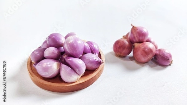 Fototapeta Red onion on wooden plate. Isolated on white background with copy space. Perfect for design element, ingredients food spices or any commercial usage.