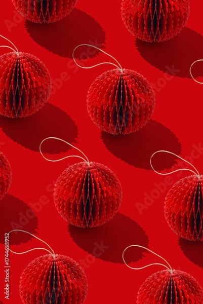 Fototapeta Minimalist top view of red honeycomb paper Christmas ornaments, Crafted round balls as holiday minimal trend pattern, winter seasonal festive red decorations, Happy holidays, Merry Christmas concept