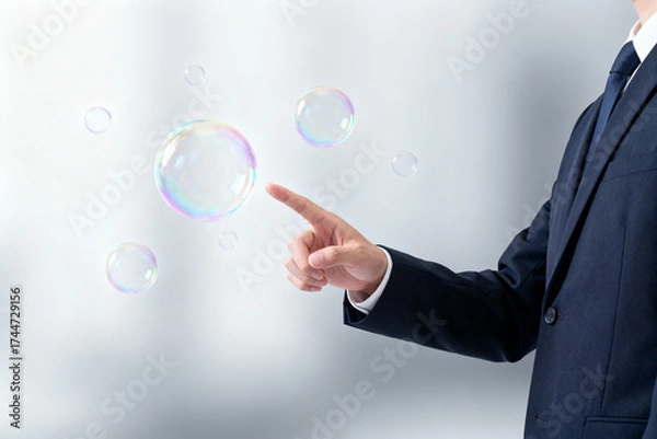 Fototapeta Man in suit pointing at floating bubbles