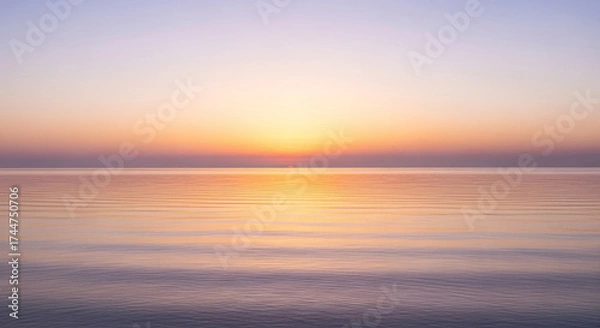Obraz The sun rises over the ocean, casting a warm glow on the water and creating a beautiful and peaceful scene at the start of a new day