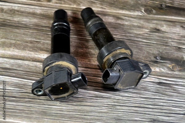 Obraz used broken ignition coils, the induction coil for automobile ignition system that transforms battery voltage to thousands of volts needed to create an electric spark plugs to ignite fuel