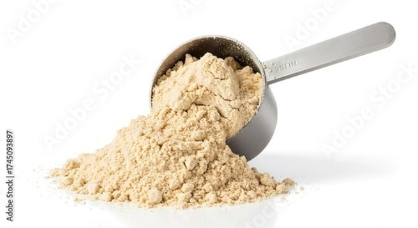 Fototapeta A measuring cup spills light brown powder on a white surface with a shadow