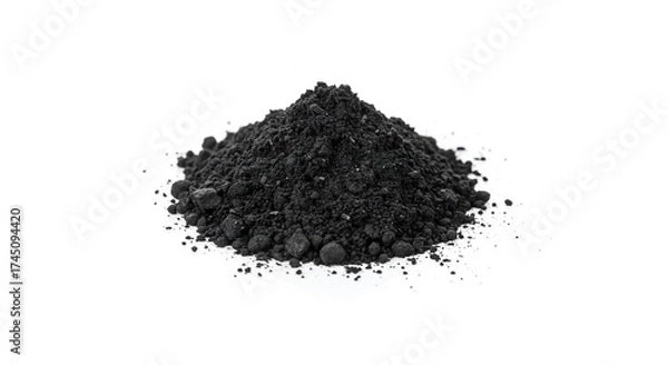 Fototapeta A mound of dark granular material rests against a stark white backdrop