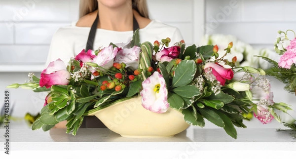 Obraz Florist presenting beautiful mixed floral arrangement