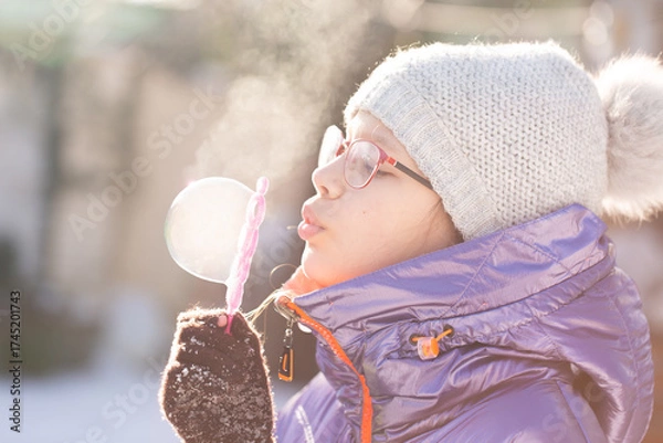 Obraz Child focused on winter bubble making