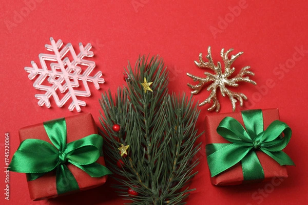 Fototapeta Festive scene with wrapped gifts, candies and decorations, sometimes on a bright red background, conveying Christmas greetings and celebration
