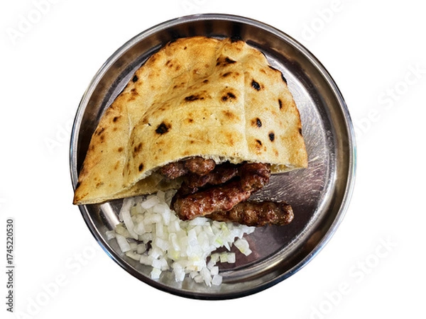 Fototapeta Delicious flatbread filled with spiced meat served on a silver plate with chopped onions