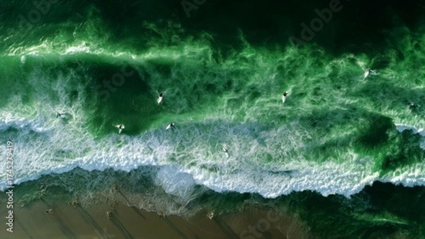 Fototapeta Aerial view of surfers riding green ocean waves. AI image