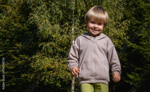Fototapeta Happy child walking in the forest