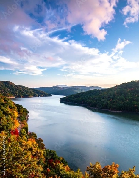 Fototapeta Serene autumnal vista of a winding lake nestled in a mountainous landscape