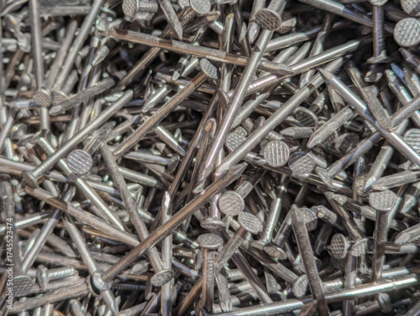 Obraz Close-Up of Shiny Metal Nails Piled Together at a Construction Site