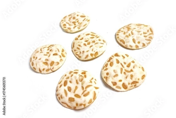 Fototapeta Keripik Tempe or Tempeh Chips isolated on white background with copy space. Traditional Indonesian food are made from soybeans mixed with rice flour then sliced ​​thinly. Suitable fot design element.