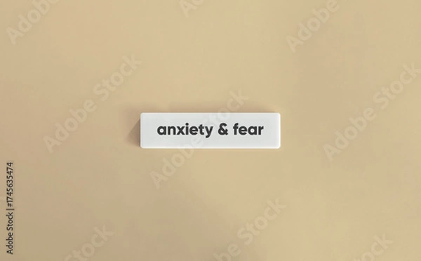 Fototapeta Anxiety and Fear Text on White Letter Tile over Beige Background