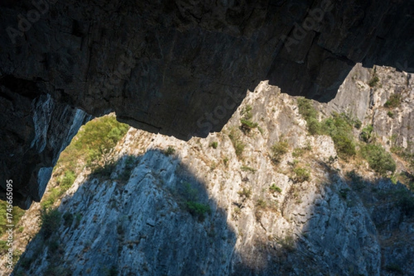 Fototapeta Abstract  Upper and Lower Jaw of the Beast. State of Mind, Balance and Contrast. Natural Cliff background.
