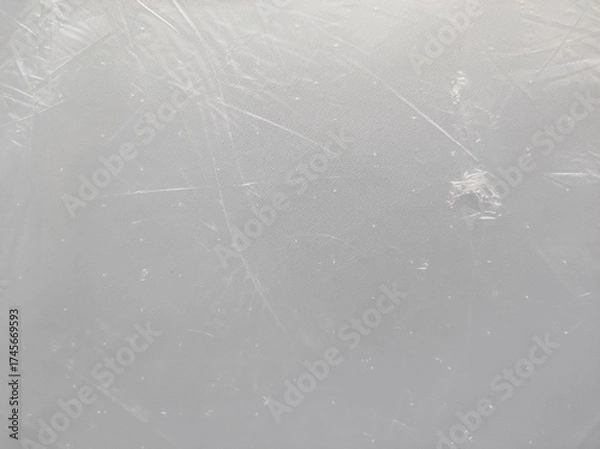 Obraz A light gray textured background. A transparent, worn plastic bag with with subtle scratches and imperfections.