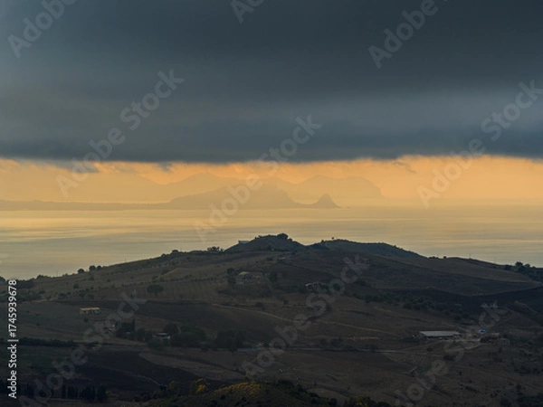 Fototapeta Aerial drone view of Capo Zafferano, a scenic Sicilian coastal promontory in the Metropolitan City of Palermo, Italy, featuring distant views of the Tyrrhenian Sea and the majestic Madonie Mountains