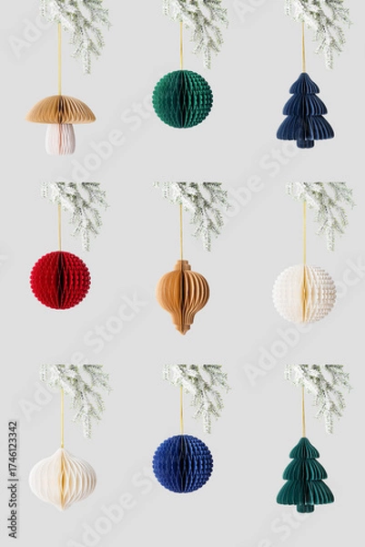 Fototapeta Minimal style set photo of colorful paper Christmas ornaments of different shapes hanging on white snow fir branch on neutral background Concept of holiday decoration, eco design, festive aesthetics.