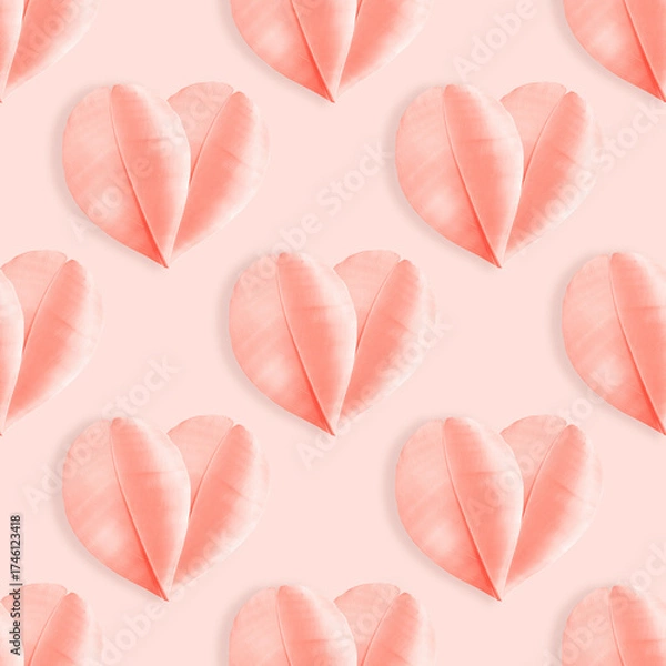 Fototapeta Minimal aesthetic seamless pattern of Pink hearts from feathers on pastel peach background. Symbol of love and romance, holiday greetings for Valentine Day, pink monochrome photo, top view layout