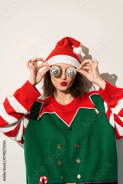 Fototapeta Santa elf character in festive outfit with novelty Christmas tree shaped glasses