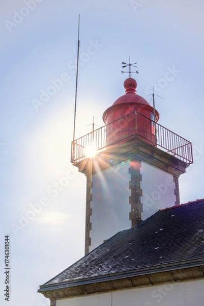 Fototapeta Sunbeams at an old lighthouse in Bretagne