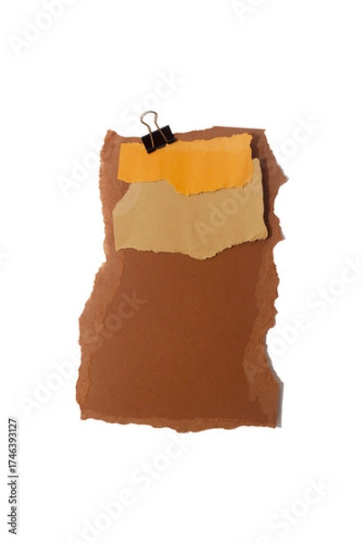 Fototapeta Torn piece of brown piece of paper with beige tape and black binder isolated on white background