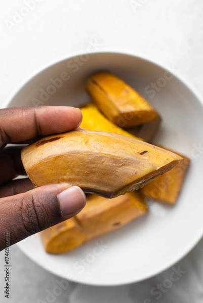 Fototapeta overhead view of Boiled ripe plantain in a white bowl, top view of nigerian cooked ripe plantain